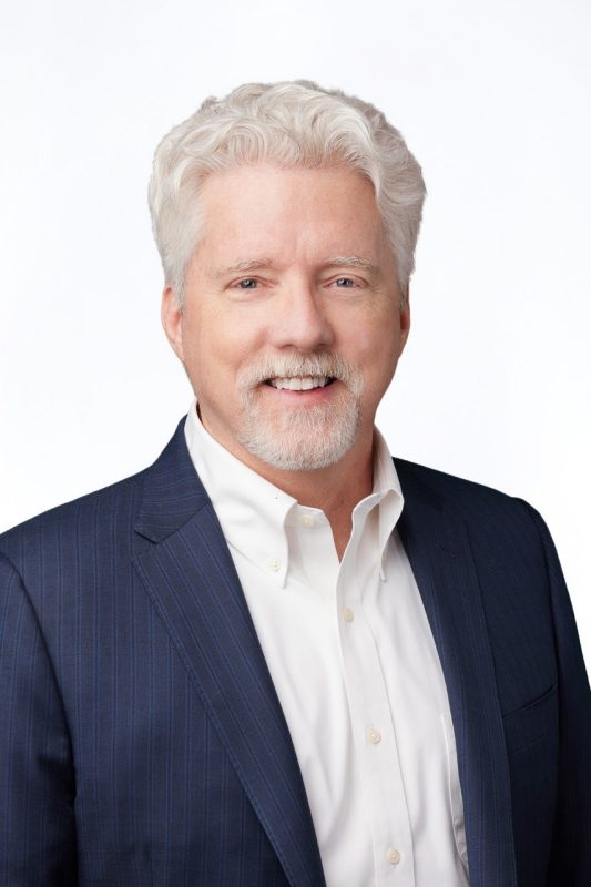 Marcus Wilson portrait of man with white hair in business attire