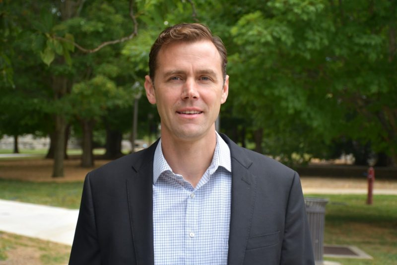 Scarola poses outside on campus with trees